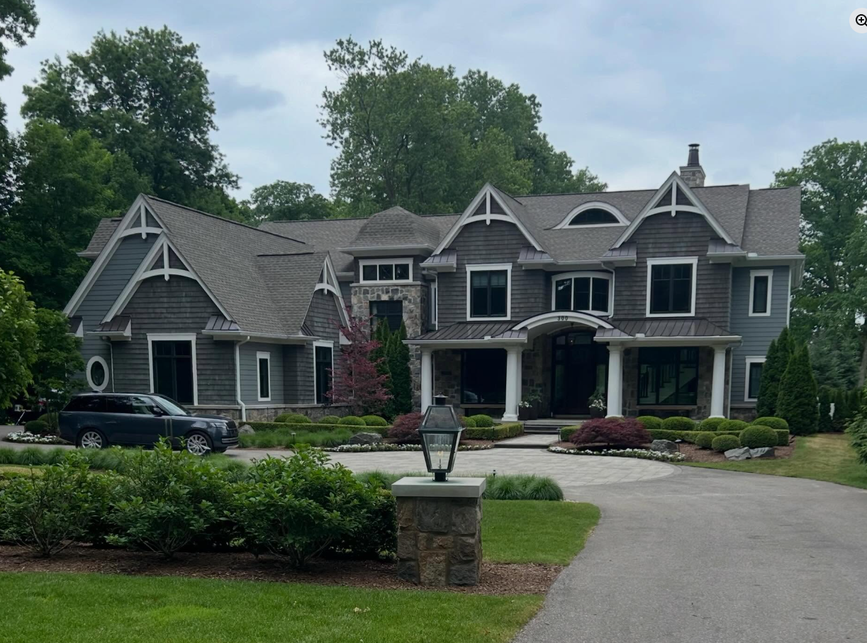 Grand shingle-style estate in Bloomfield Hills with freshly cleaned windows across all dormers and gables by Apex Exteriors
